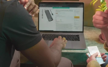 Stock Video Man And Woman Buying Online On A Laptop Animated Wallpaper
