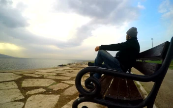 Stock Video Man Admiring The Sea On A Bench At The Pier Animated Wallpaper