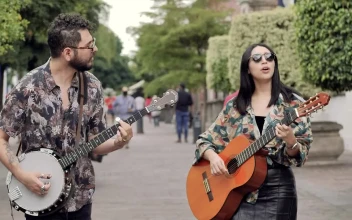 Stock Video Male And Female Friends Walking Through A Park While Playing Animated Wallpaper