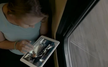 Stock Video Looking At Photos On A White Tablet Animated Wallpaper