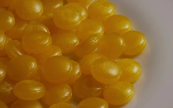 Stock Video Little Yellow Candies Turning Slow On A Plate Animated Wallpaper