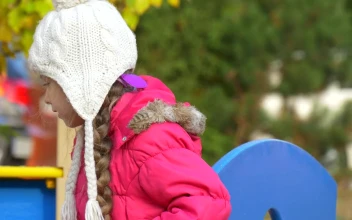 Stock Video Little Girl With A Winter Hat On The Playground Animated Wallpaper