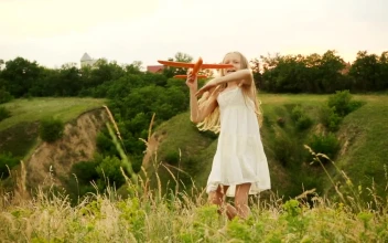 Stock Video Little Girl Throwing A Toy Plane In The Hills Animated Wallpaper