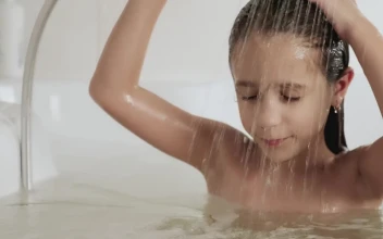 Stock Video Little Girl Rinsing Out The Shampoo From Her Hair In Animated Wallpaper