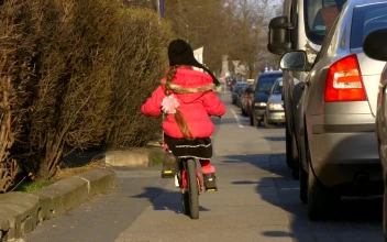 Stock Video Little Girl Riding A Bike Through The Streets Animated Wallpaper