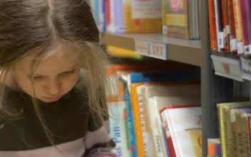 Stock Video Little Girl Reading A Book In A Library Animated Wallpaper
