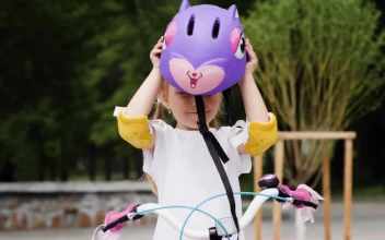 Stock Video Little Girl Puts On A Protective Bicycle Helmet Animated Wallpaper