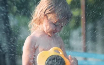 Stock Video Little Girl Playing With Water In The Garden Animated Wallpaper