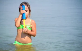 Stock Video Little Girl Playing With A Water Toy In The Sea Animated Wallpaper