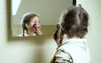 Stock Video Little Girl Playing Makeup In The Mirror Animated Wallpaper