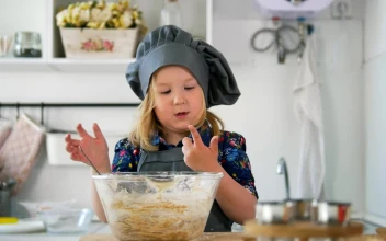 Stock Video Little Girl In A Kitchen Stirring A Cookie Mix Animated Wallpaper
