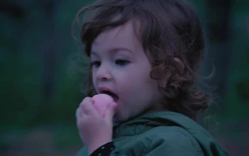 Stock Video Little Girl In Nature Eating A Marshmallow Animated Wallpaper