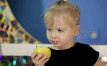 Stock Video Little Girl Eating An Apple Animated Wallpaper