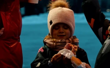 Stock Video Little Girl Eating A Donut On An Ice Rink Animated Wallpaper