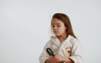 Stock Video Little Girl Combing Her Hair After Shower Animated Wallpaper