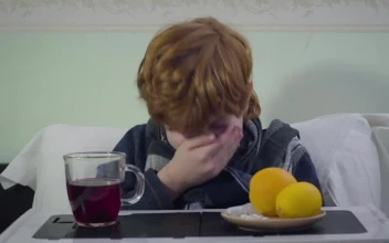 Stock Video Little Boy Sneezes While Sick In Bed With Breakfast Animated Wallpaper