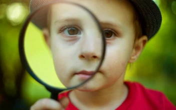Stock Video Little Boy Looking Through A Magnifying Glass Animated Wallpaper