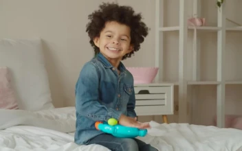 Stock Video Little Boy Happily Playing With A Toy Animated Wallpaper
