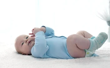 Stock Video Little Baby Lying On His Back Wearing Blue Pajamas Animated Wallpaper