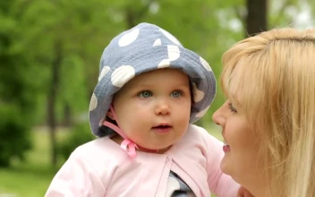 Stock Video Little Baby In His Mothers Arms Looking Around Animated Wallpaper