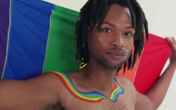 Stock Video Lgbtq Man Looking At The Camera With His Flag Animated Wallpaper