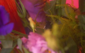 Stock Video Lgbtq Boy Looking At Camera Surrounded By Flowers Animated Wallpaper