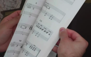 Stock Video Leafing Through A Notebook With Sheet Music Animated Wallpaper