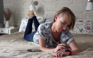 Stock Video Laying On A Bed Checking Her Smartwatch Animated Wallpaper