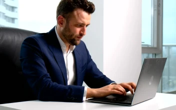 Stock Video Lawyer Types On Laptop In Highrise Office With City View Animated Wallpaper