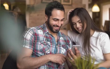 Stock Video Laughing Couple Scroll Through Social Media On Mobile Animated Wallpaper