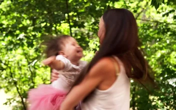 Stock Video Mother Spinning Her Child In The Garde Animated Wallpaper