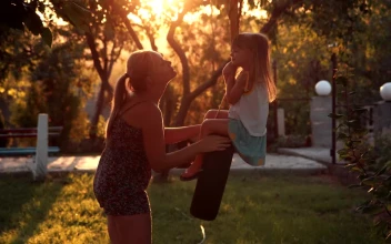 Stock Video Mother Kissing Her Daughter On The Tire Swin Animated Wallpaper