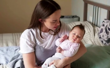 Stock Video Mother Holding Her Baby In Her Arm Animated Wallpaper