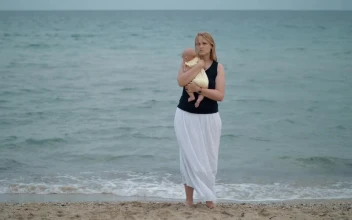 Stock Video Mother Holding Her Baby Alone At The Shor Animated Wallpaper