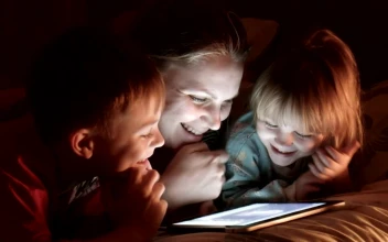Stock Video Mother And Kids Watching Tablet On The Be Animated Wallpaper