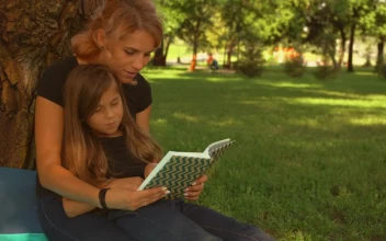 Stock Video Mother And Daughter Read A Book Together In A Par Animated Wallpaper