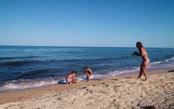 Stock Video Mom Taking Photos Of Her Daughters Sand Pyramid Animated Wallpaper
