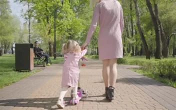 Stock Video Mom Leads Daughter On Scooter Through Par Animated Wallpaper