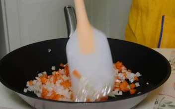 Stock Video Mixing Chopped Vegetables In A Frying Pa Animated Wallpaper