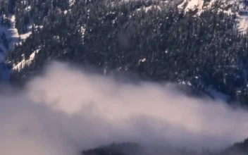 Stock Video Mist At The Base Of A Snowy Mountai Animated Wallpaper