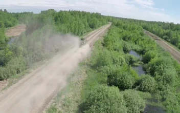 Stock Video Military Vehicle Heading Down A Dusty Roa Animated Wallpaper