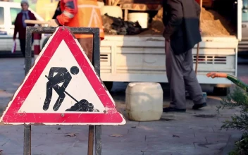 Stock Video Men Cleaning A Street With A Dirt Road Sign Animated Wallpaper