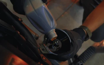 Stock Video Mechanic Pouring Oil Into An Engin Animated Wallpaper