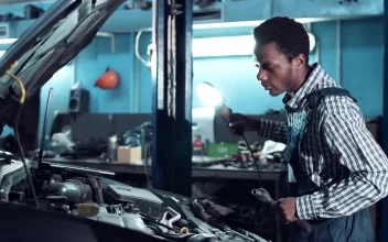 Stock Video Mechanic Inspecting Motor With A Ligh Animated Wallpaper