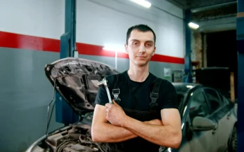 Stock Video Mechanic Holding A Repair Tool With A Broken Car I Animated Wallpaper