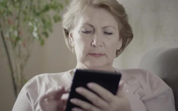 Stock Video Mature Woman Using An Electronic Reading Devic Animated Wallpaper