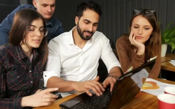Stock Video Marketing Team Gather Around Laptop And Smile At Camer Animated Wallpaper