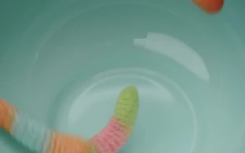 Stock Video Many Sugary Gum Worms Falling Into A Bow Animated Wallpaper
