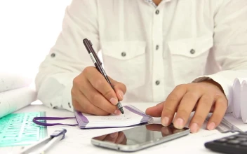 Stock Video Man Writing In A Notebook At His Offic Animated Wallpaper