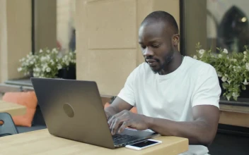 Stock Video Man Working Remotely From A Coffee Sho Animated Wallpaper